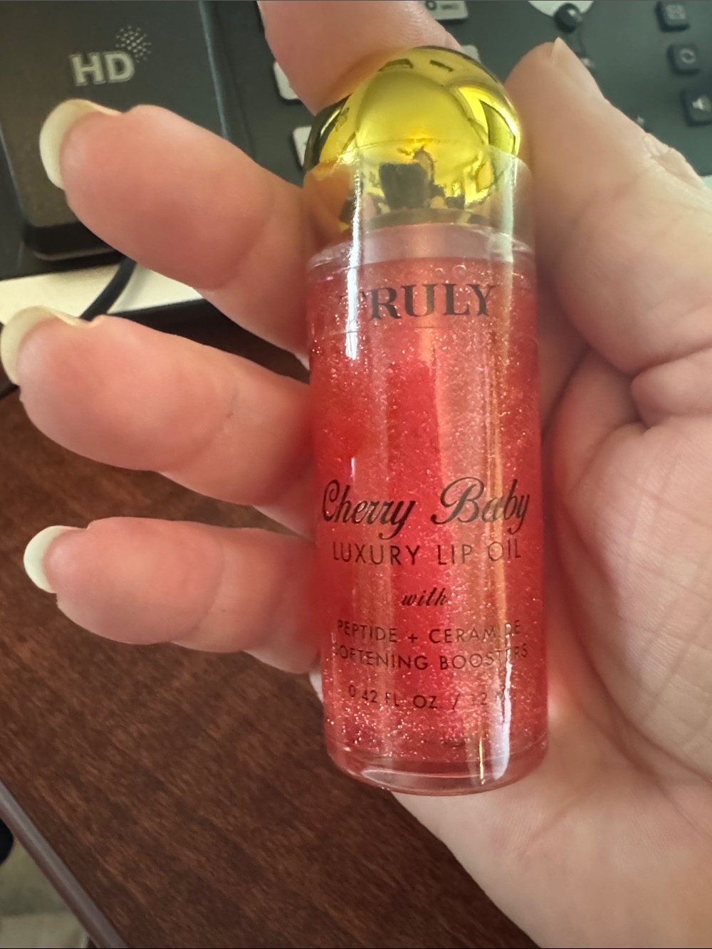 TRULY Cherry Baby Lip Oil - Shimmery Gold Cap with Red Glitter Oil